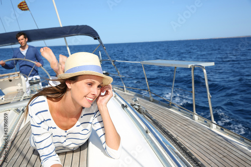 Beautiful woman with hat enjoying cruising on boat © goodluz
