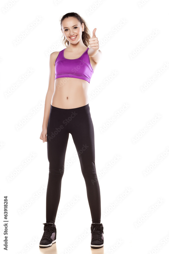 young sporty girl showing thumb up on white young sporty girl showing thumb up on white