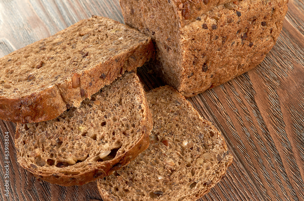 Slices of brown bread on a wooden table Slices of brown bread on a wooden table