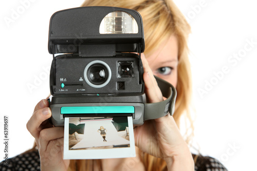 Girl with old point and shoot instant camera