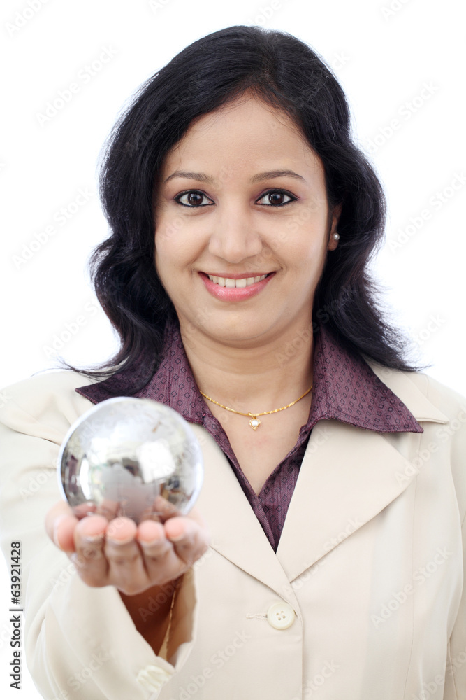 Young Indian business woman holding puzzle globe against white Young Indian business woman holding puzzle globe against white