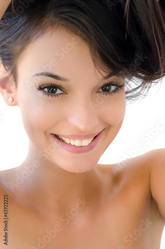 Portrait of a beautiful brunette girl with hair up smiling.