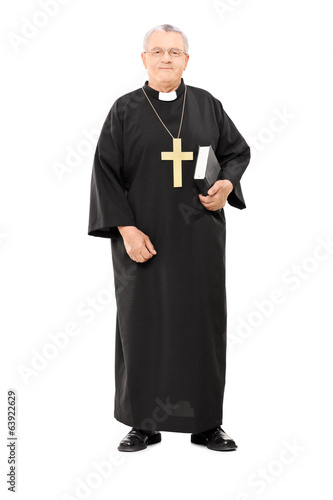 Fotografie Mature priest holding a holy bible