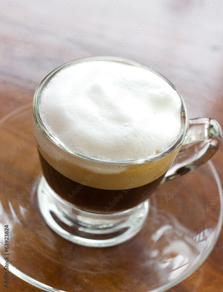 Hot espresso with milk and foam in cup. Hot espresso with milk and foam in cup.