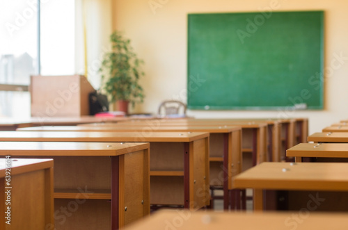 Classroom with desks and a green blackboard