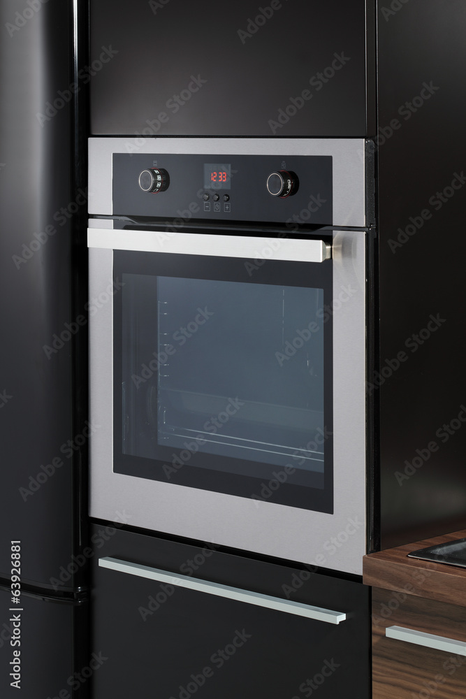 Fototapeta premium Electric oven built into kitchen furniture