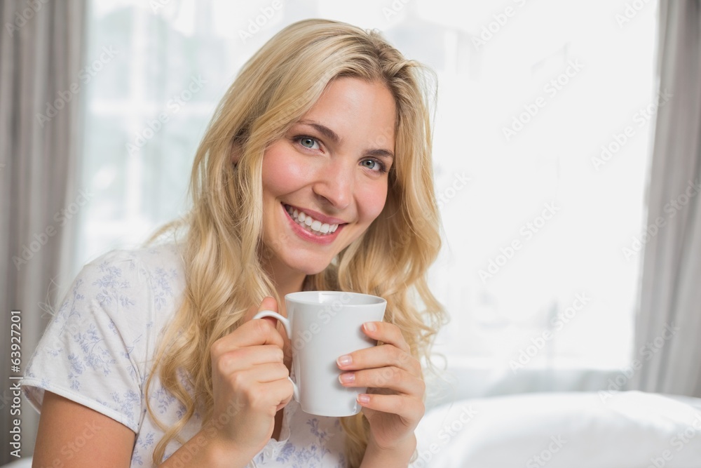 Beautiful casual young woman holding coffee cup Beautiful casual young woman holding coffee cup