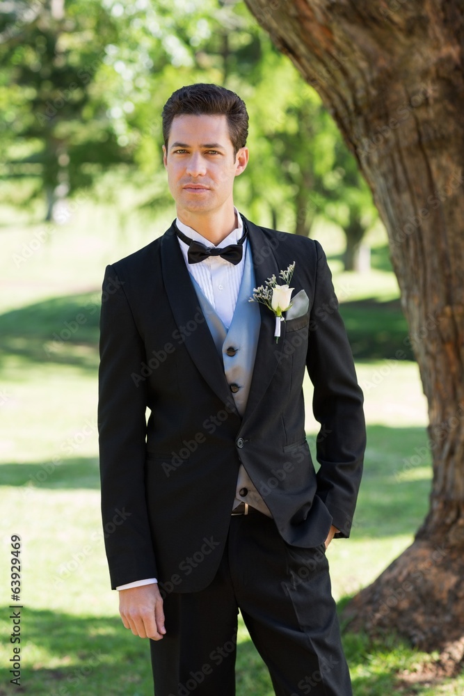 Confident bridegroom in tuxedo at garden Confident bridegroom in tuxedo at garden