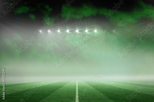 Football pitch under green sky