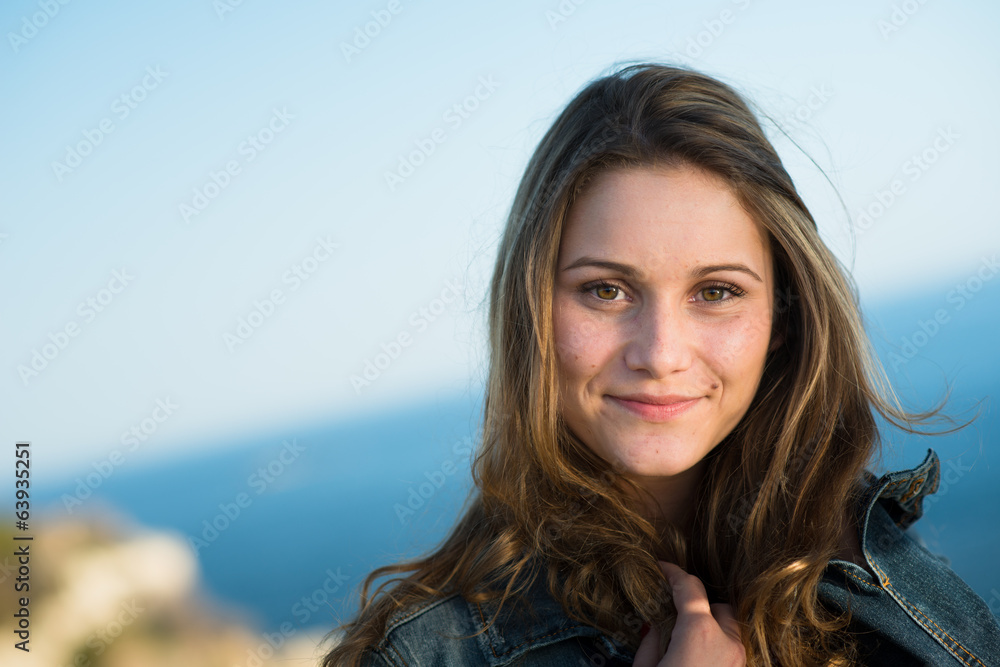 isolated portrait of a cheerful young women by the sea in summer isolated portrait of a cheerful young women by the sea in summer