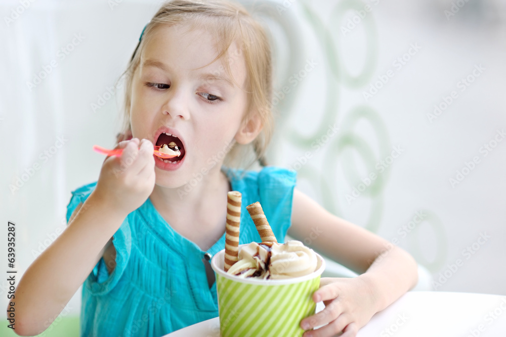 Adorable little girl eating ice cream Adorable little girl eating ice cream