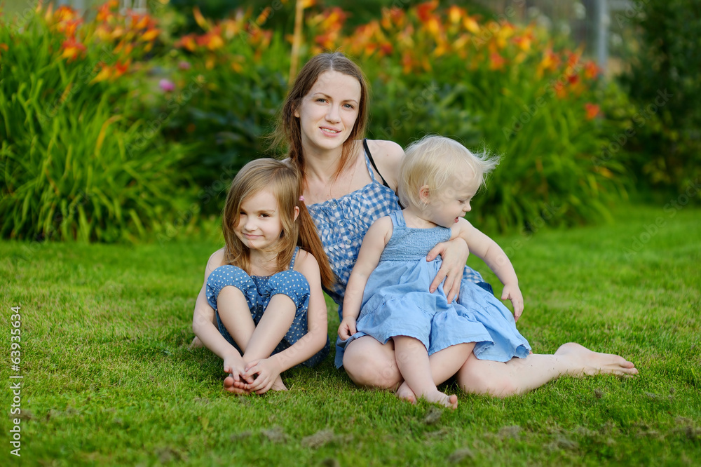 Young mother and her two little daughters Young mother and her two little daughters