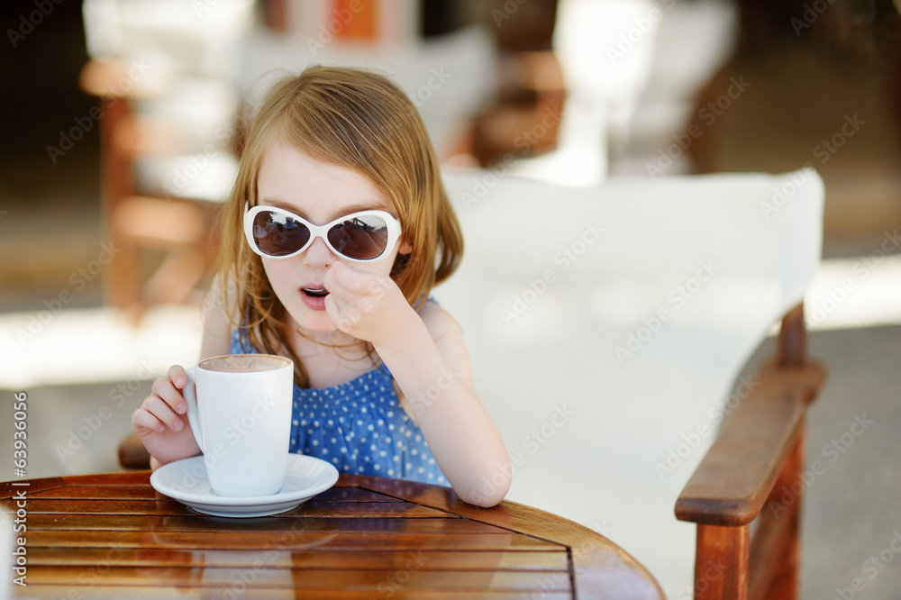 A girl drinking hot chocolate in outdoor cafe A girl drinking hot chocolate in outdoor cafe