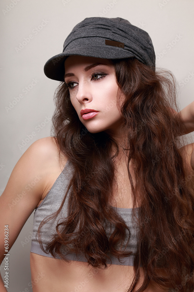 Sexy young woman with long hair in trendy cap. Hipster Sexy young woman with long hair in trendy cap. Hipster