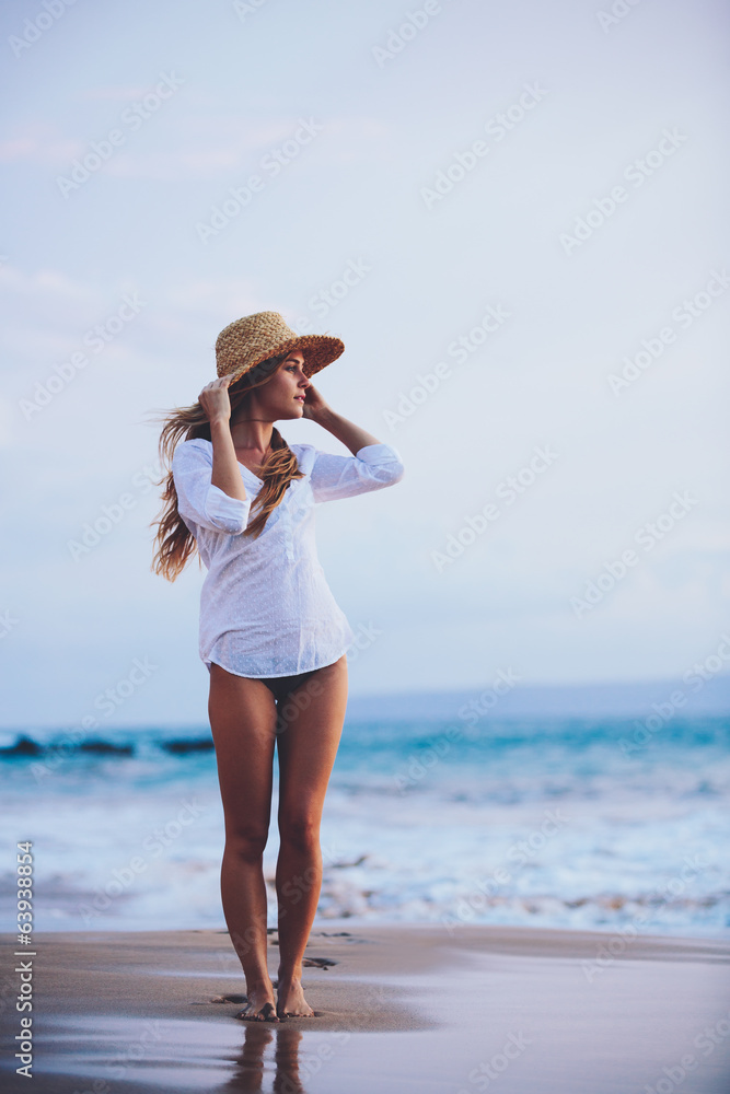 Beautiful girl on the beach at sunset