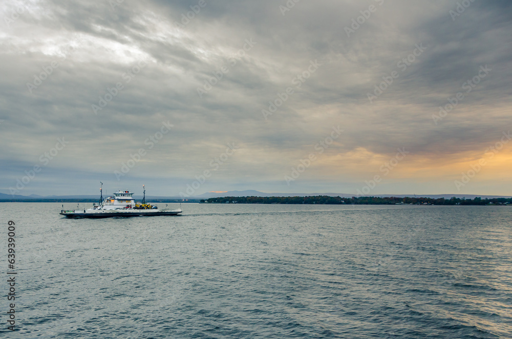 Ferry on a Lake and Cloudy Sky at Sunset