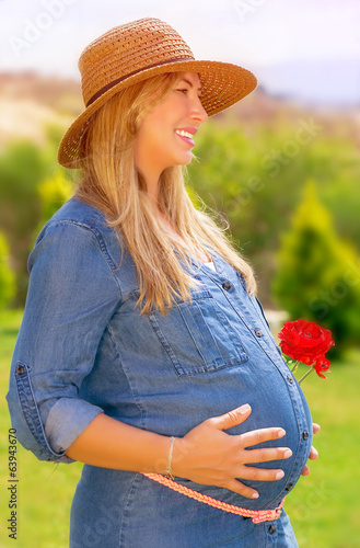 Happy pregnant woman outdoors