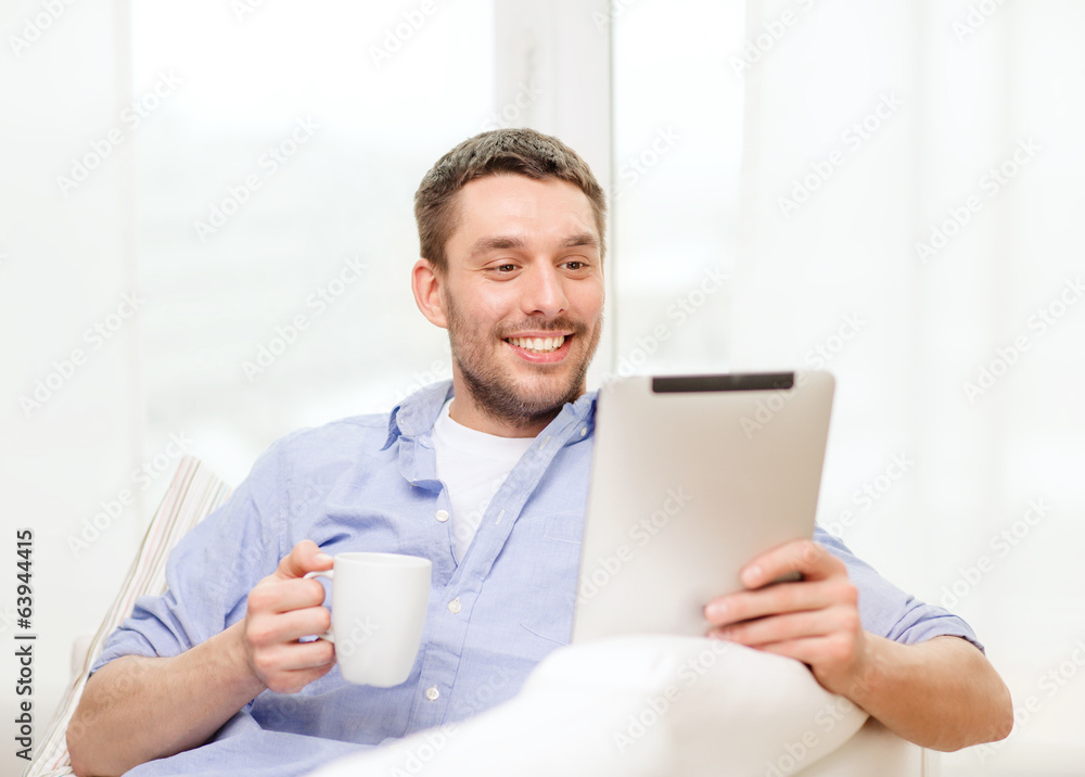 smiling man working with tablet pc at home smiling man working with tablet pc at home