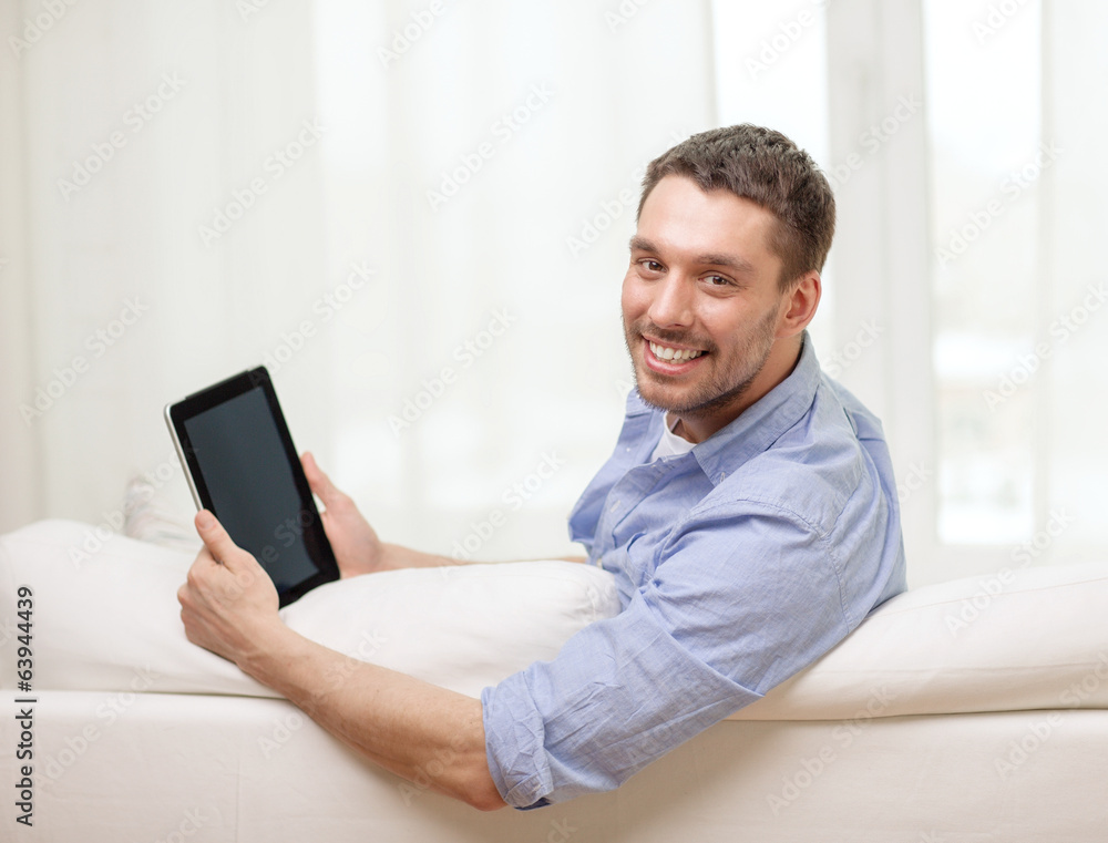 smiling man working with tablet pc at home smiling man working with tablet pc at home