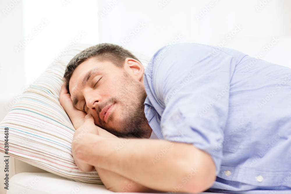 calm young man lying on sofa at home calm young man lying on sofa at home