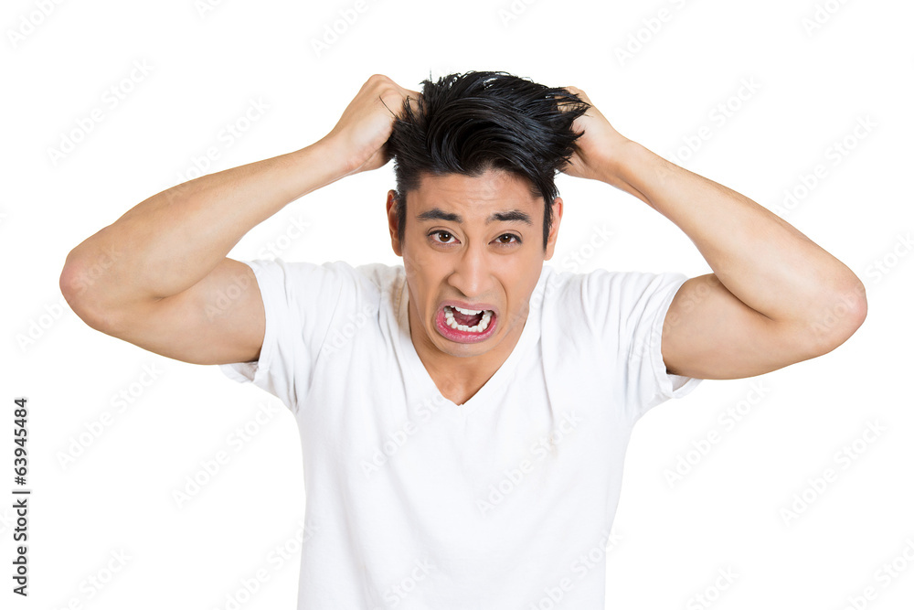 Headshot Stressed, upset, screaming young man pulling out hair Headshot Stressed, upset, screaming young man pulling out hair