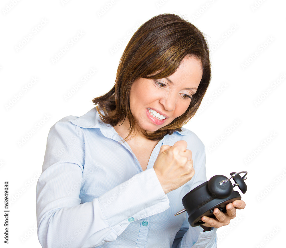 Kill time. Angry middle aged woman frustrated with alarm clock Kill time. Angry middle aged woman frustrated with alarm clock