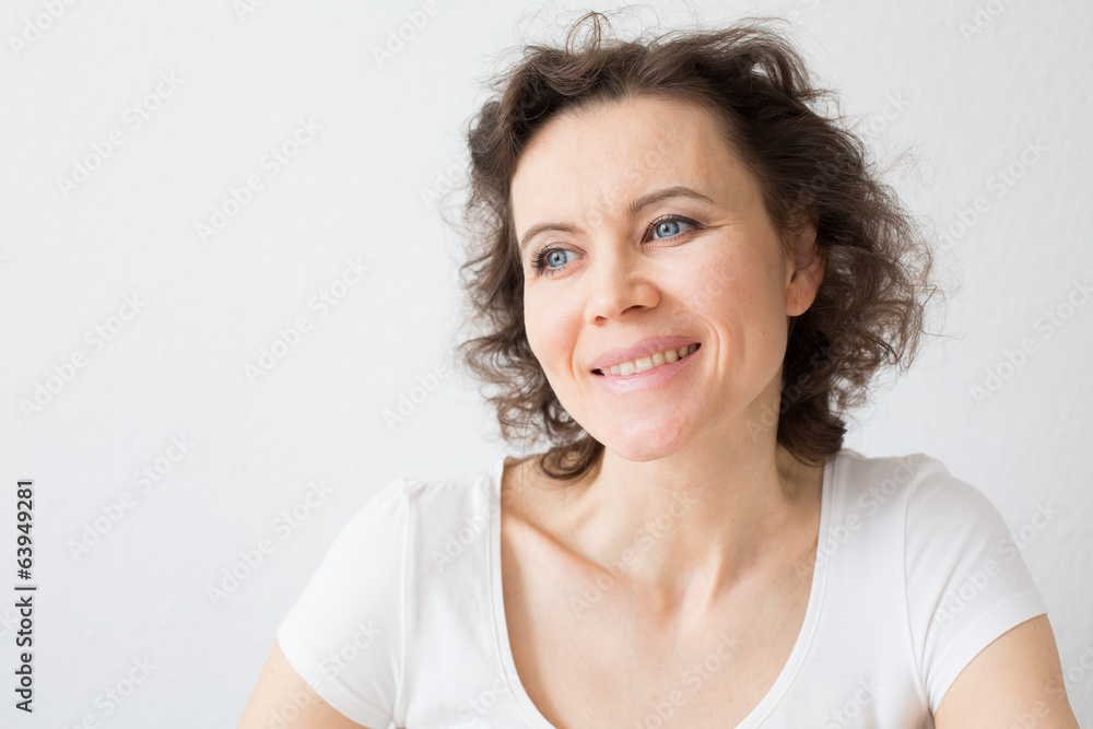 Brown-haired woman dreaming about something with hope and smilin Brown-haired woman dreaming about something with hope and smilin