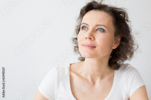Brown-haired woman dreaming about something with hope