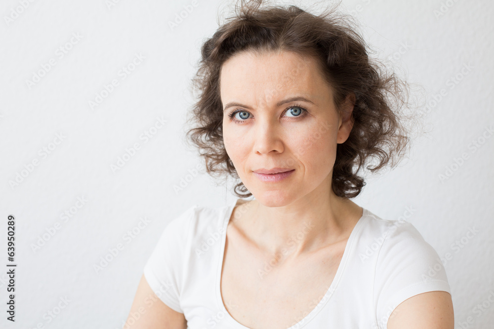 Brown-haired woman, intent look to the camera Brown-haired woman, intent look to the camera