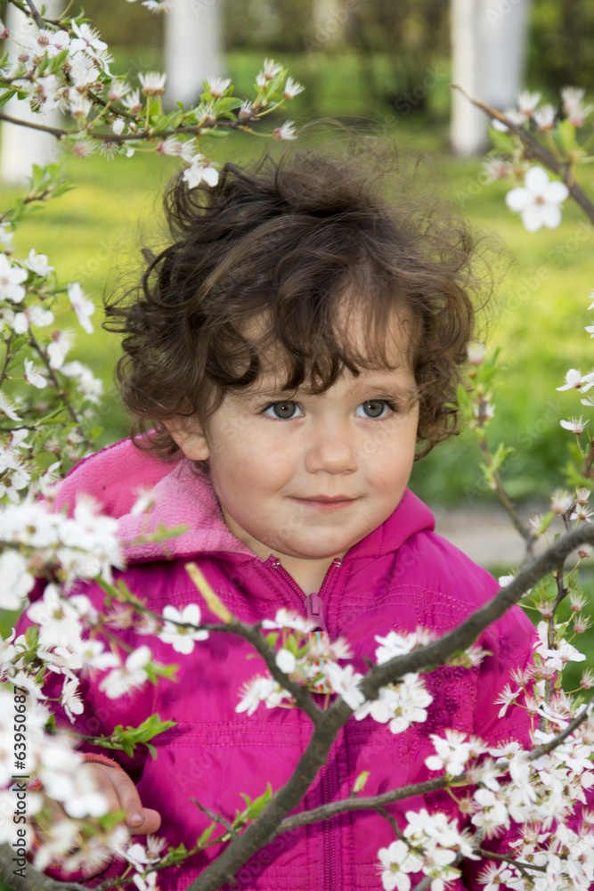 Spring in the garden a little girl holding a cherry branch. Spring in the garden a little girl holding a cherry branch.