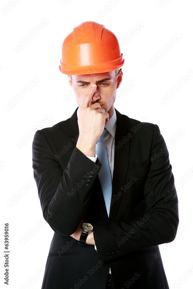 Portrait of a pensive businessman in orange helmet Portrait of a pensive businessman in orange helmet
