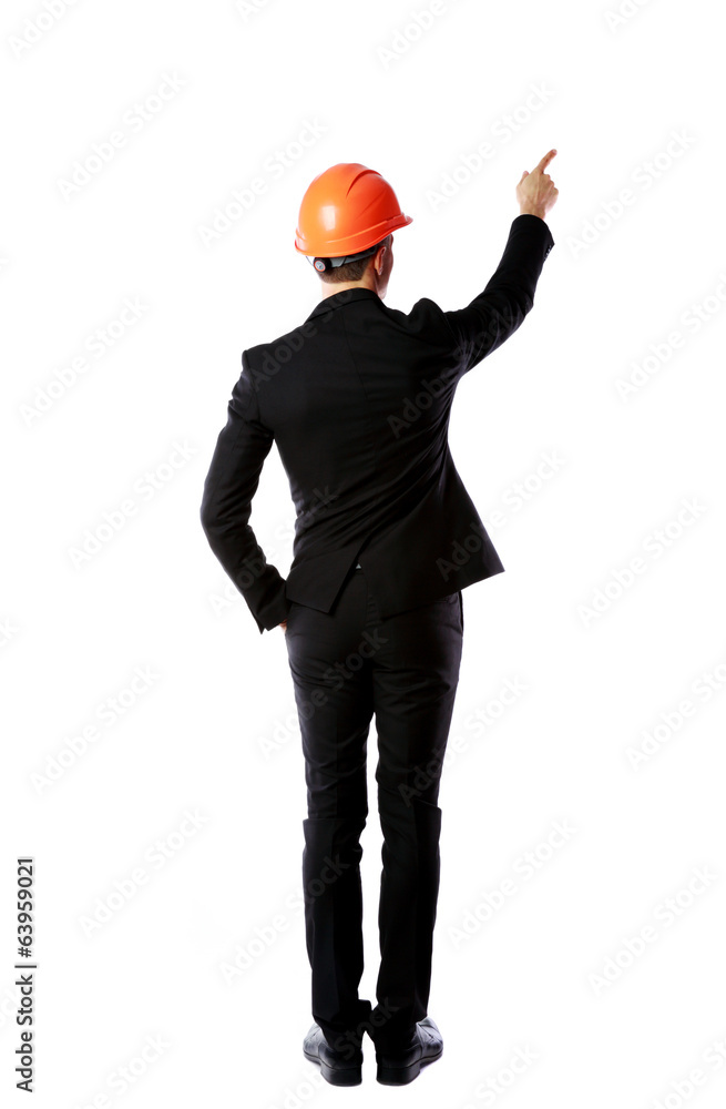 Businessman in helmet points finger up Businessman in helmet points finger up