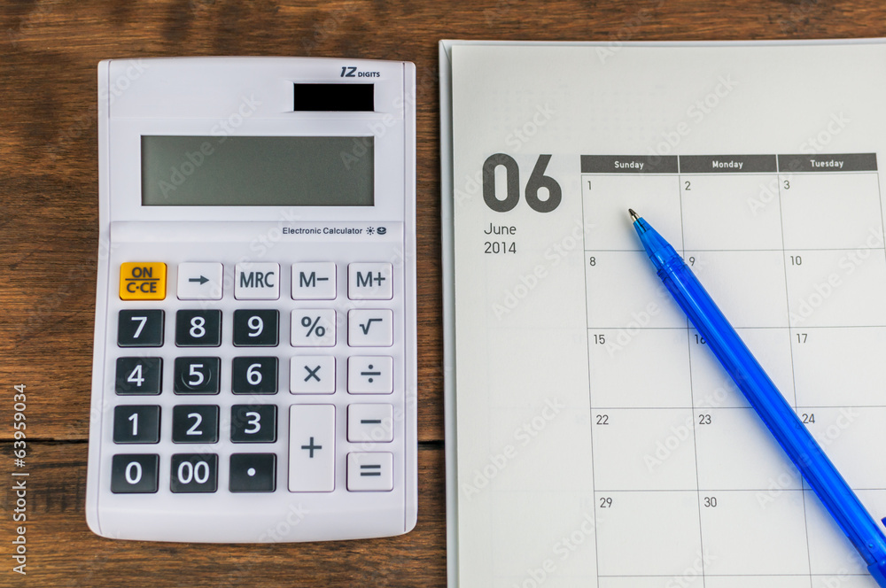 June organizer with calculator & pen: concept for monthly budget June organizer with calculator & pen: concept for monthly budget