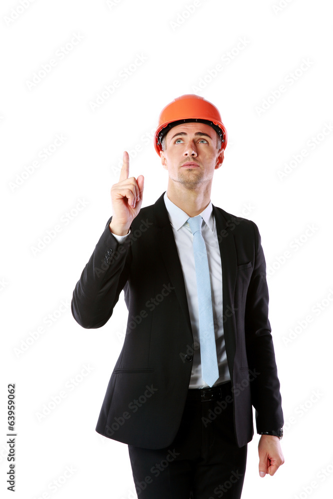 businessman in helmet pointing up at copyspace businessman in helmet pointing up at copyspace