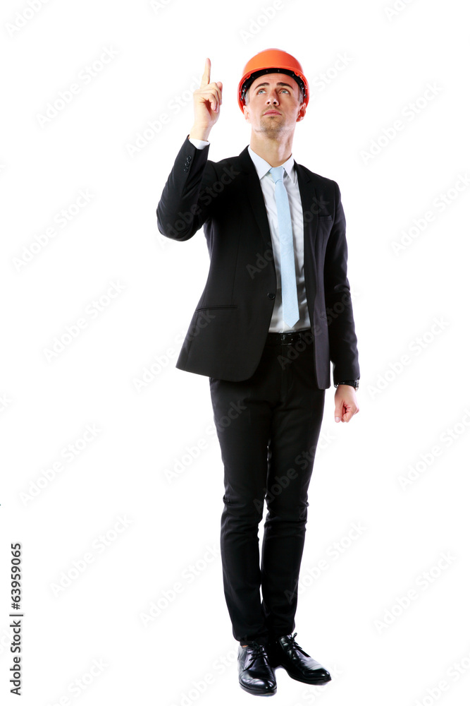 businessman in helmet pointing up at copyspace businessman in helmet pointing up at copyspace