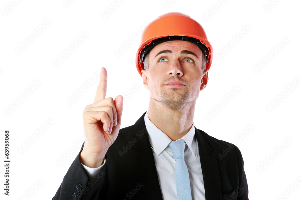 Portrait of a businessman in helmet pointing up at copyspace Portrait of a businessman in helmet pointing up at copyspace