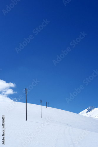 Snowy mountain scene with phone poles line © Sunlove