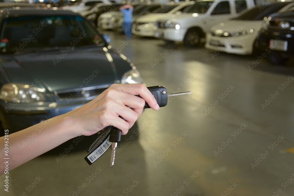 Hand with a Car keys in car park