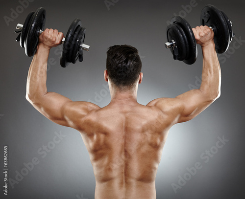 Bodybuilder back with dumbbells