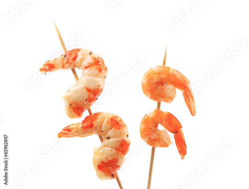Boiled shrimps on skewers.