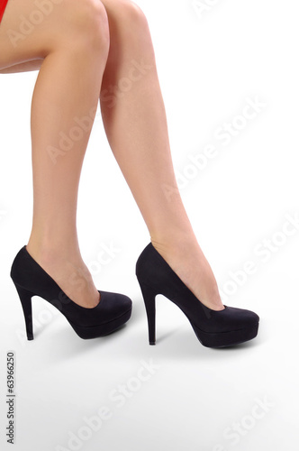 Woman legs with high heel shoes on white background