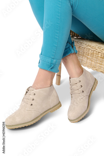 Beige cadual shoes and woman legs on white background