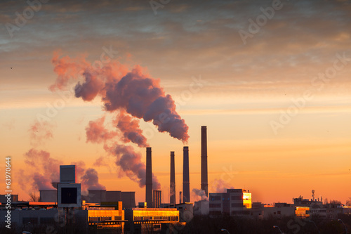 Принти на полотні Winter scenic of power plant with a burning yellow sky behind