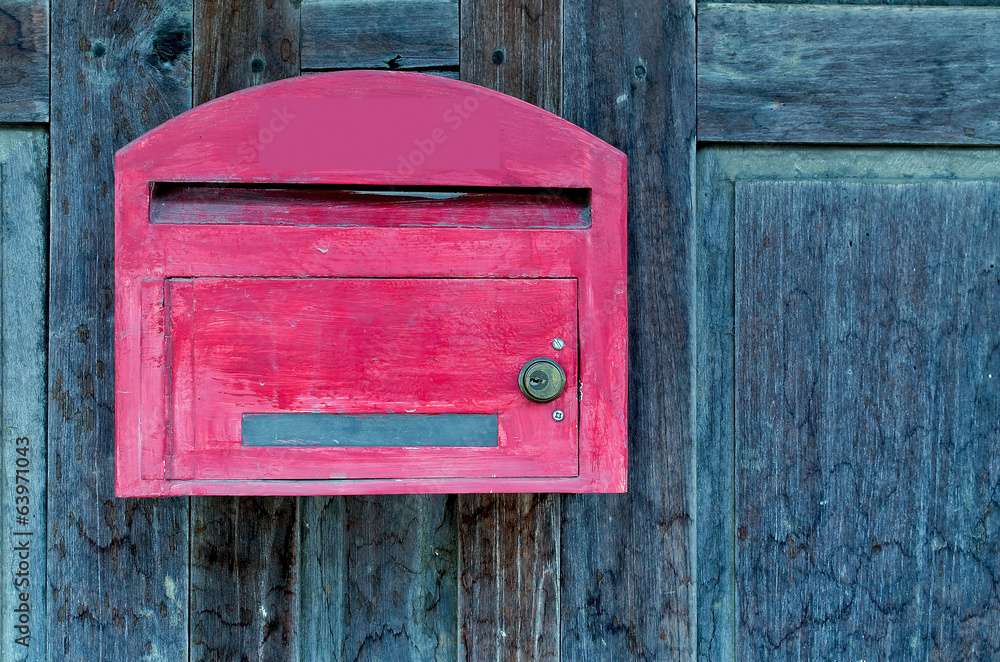 red wooden mail box on grunge wooden wall red wooden mail box on grunge wooden wall