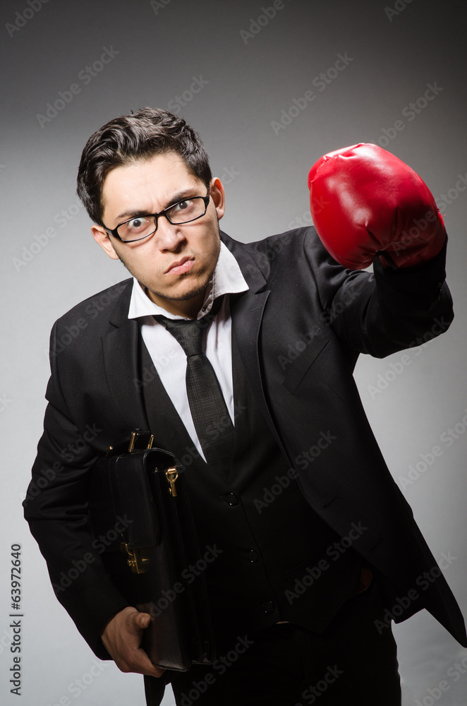 Businessman with boxing gloves in sport concept Businessman with boxing gloves in sport concept