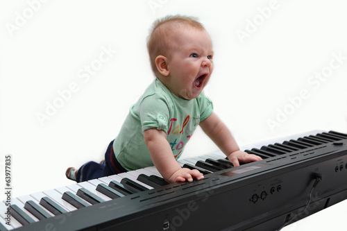 Half-year-old baby playing the piano and singing
