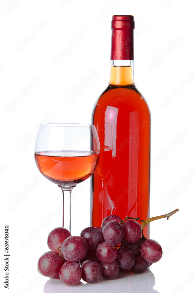 Bottle and glass of wine with red grapes