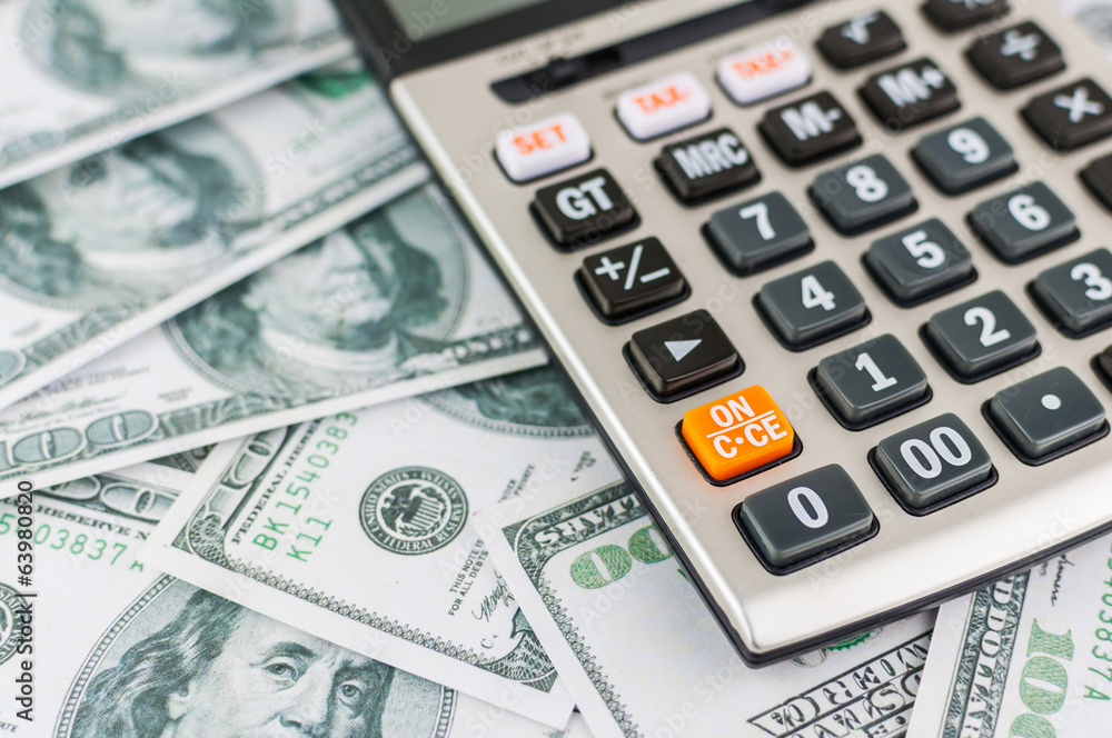 calcultor on dollar bill background calcultor on dollar bill background