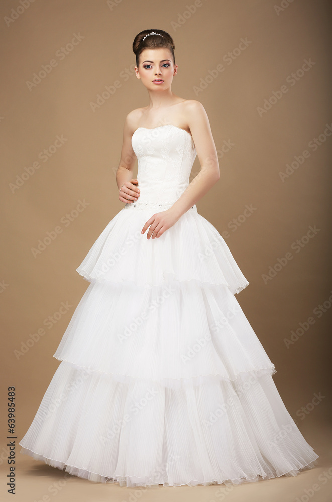 Caucasian Woman in White Long Dress Posing in Studio Caucasian Woman in White Long Dress Posing in Studio