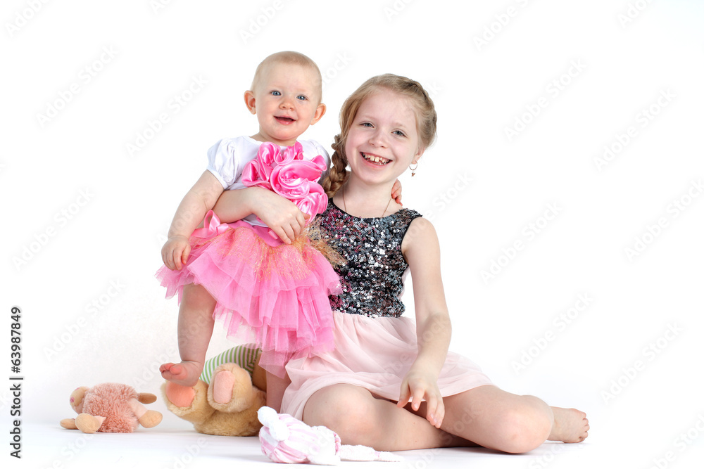 adorable little two sisters 8 year and  11 month old on white ba